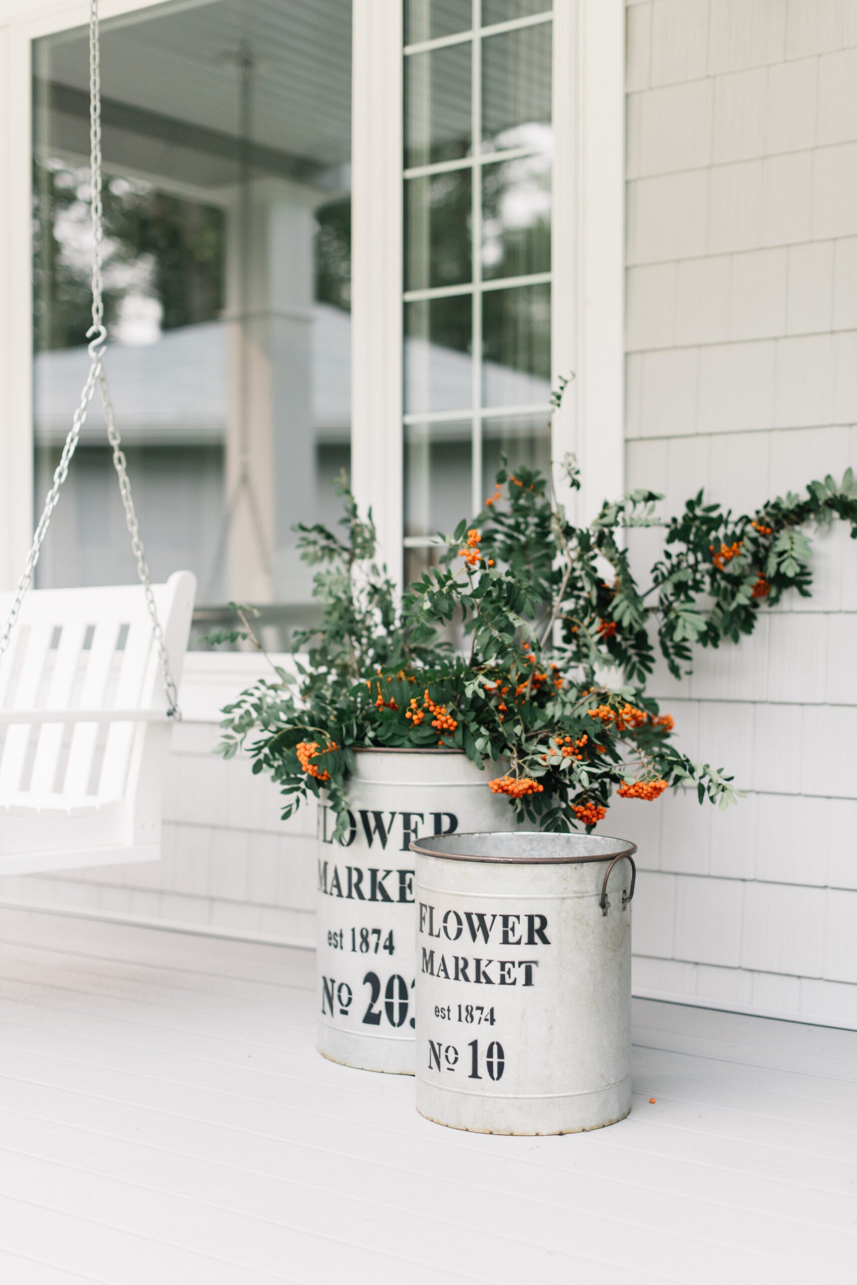 large galvanized flower buckets full of fall branches