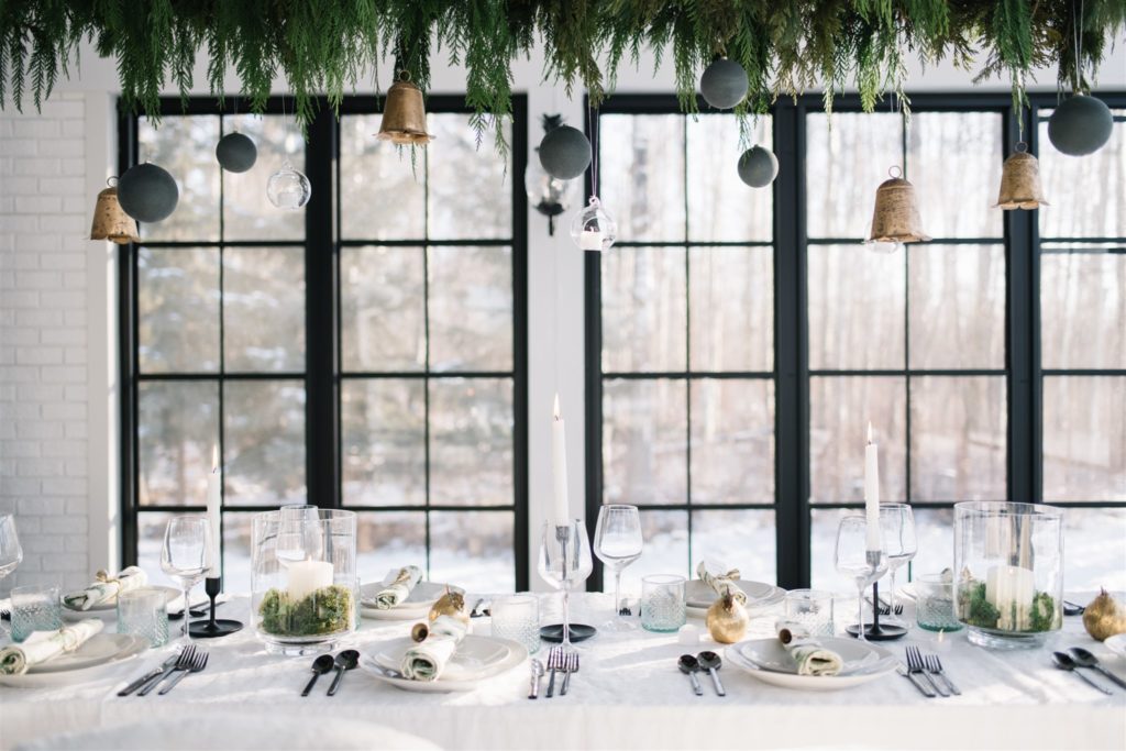 Scandinavian Christmas tablescape with hanging greenery and ornaments
