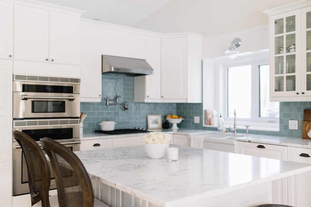A kitchen with a marble island