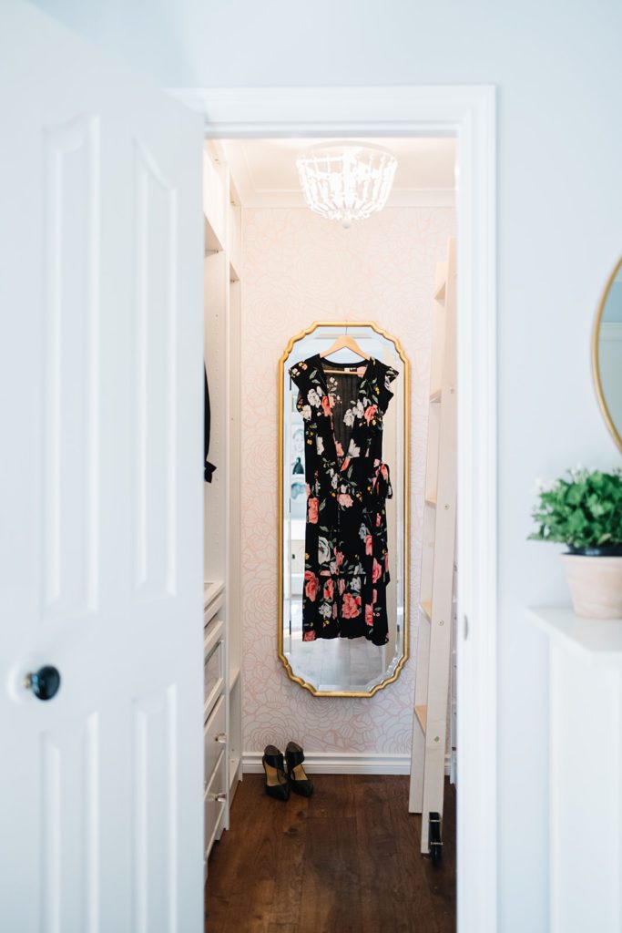 dress hanging on mirror in walk in closet