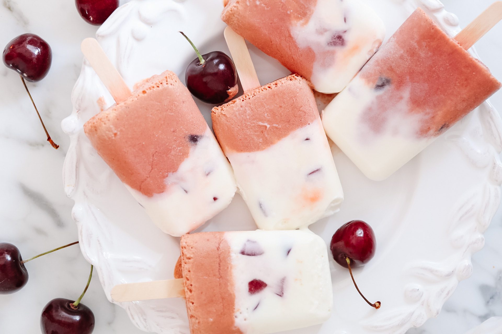 Cherry creamsicles with fresh cherries on plate