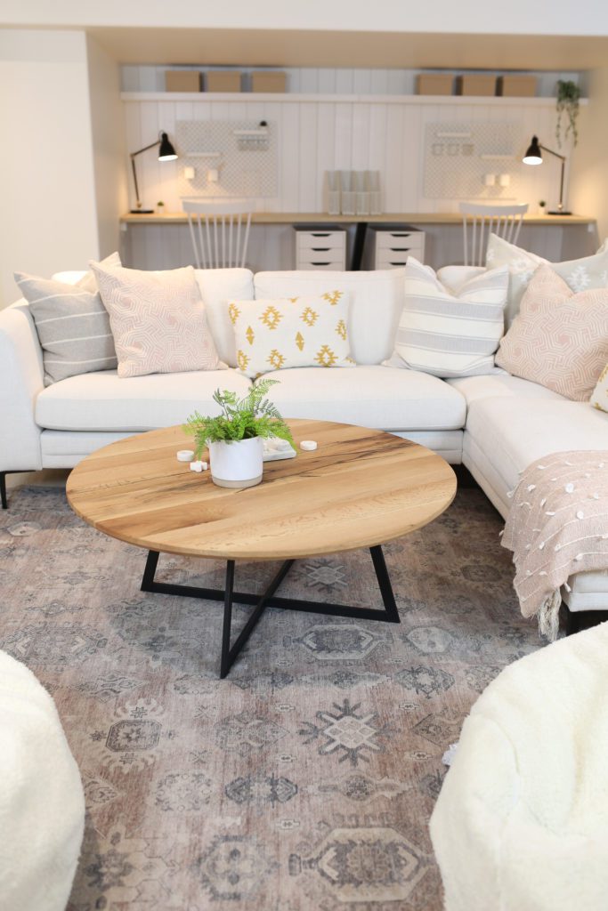 white sectional and wooden coffee table