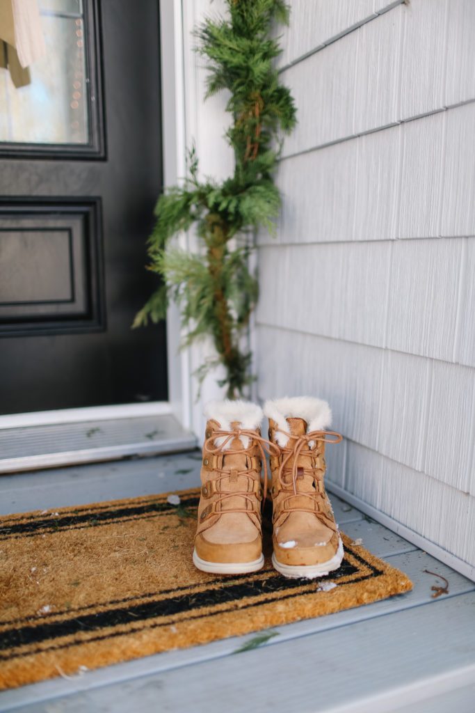 Winter boots on a front door mat