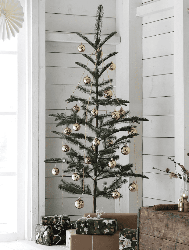 A spare Christmas tree with gold ball ornaments