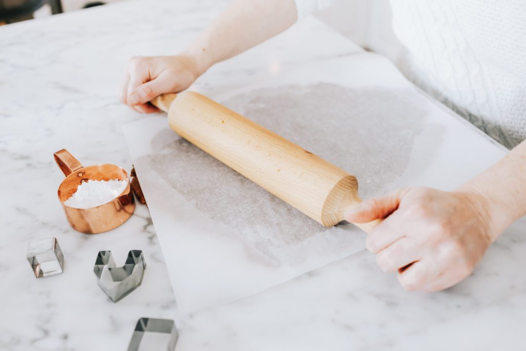 gingerbread dough being rolled with a rolling pin