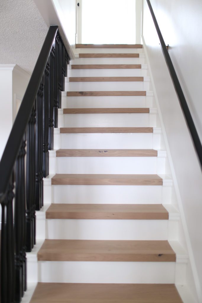 stairs with white oak treads and a black railing
